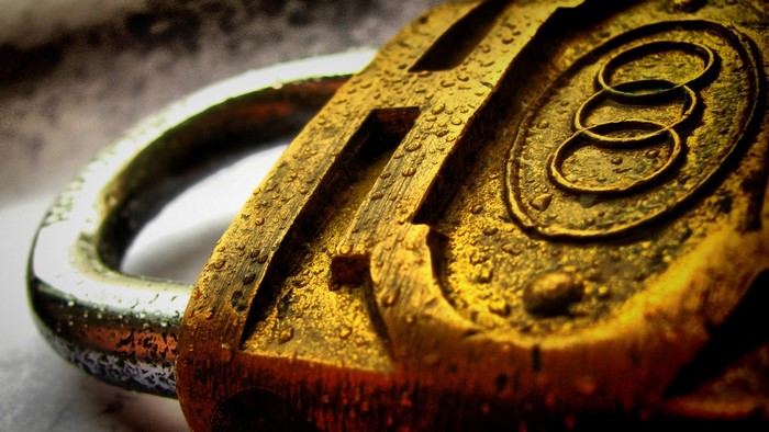 Golden Padlock with Water Droplets