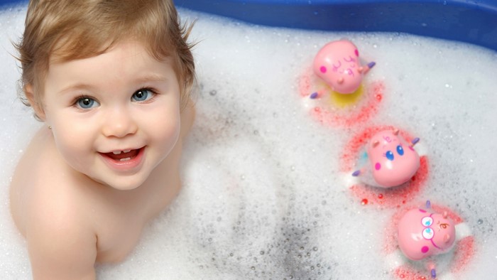 Cute Baby Girl in Bubble Bath with Toys