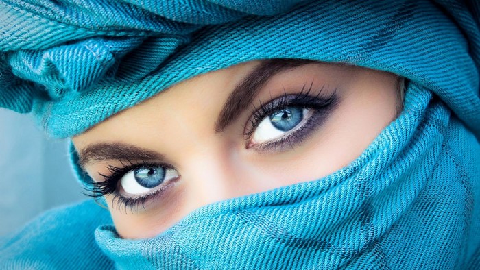 Woman with blue eyes and blue headscarf