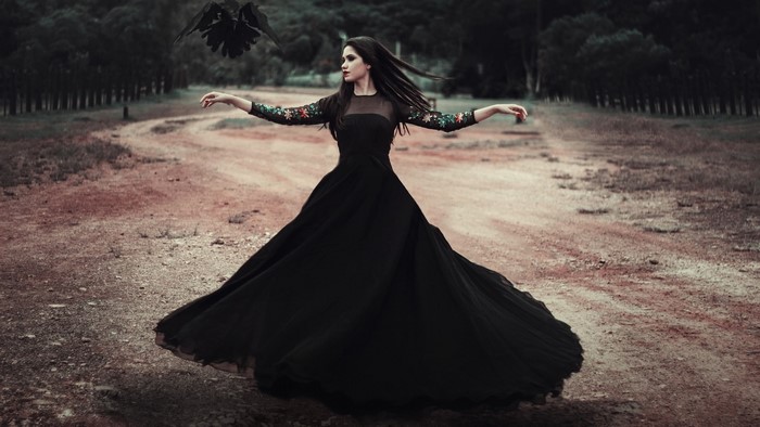 Girl in black dress with raven