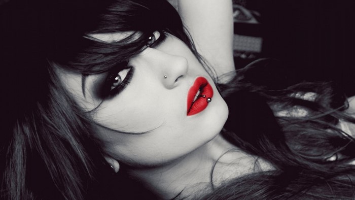 Woman with red lipstick and piercings