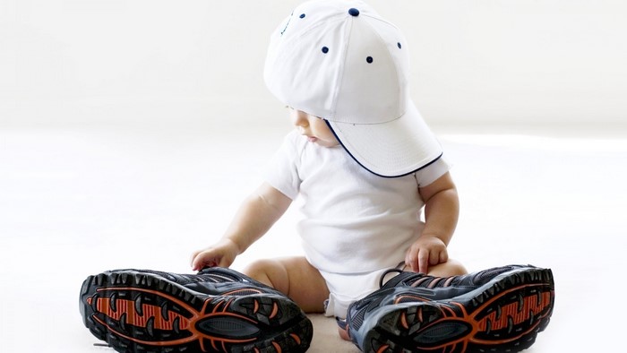 Baby in a white cap with shoes