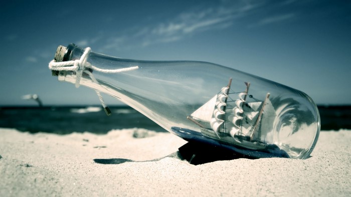Ship in a bottle on a beach