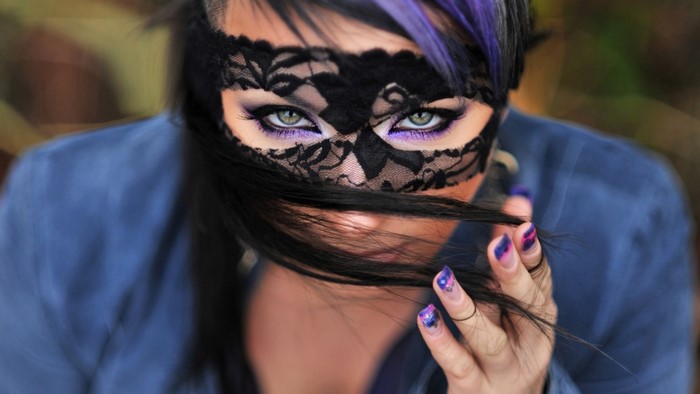 Woman with black lace mask and purple hair
