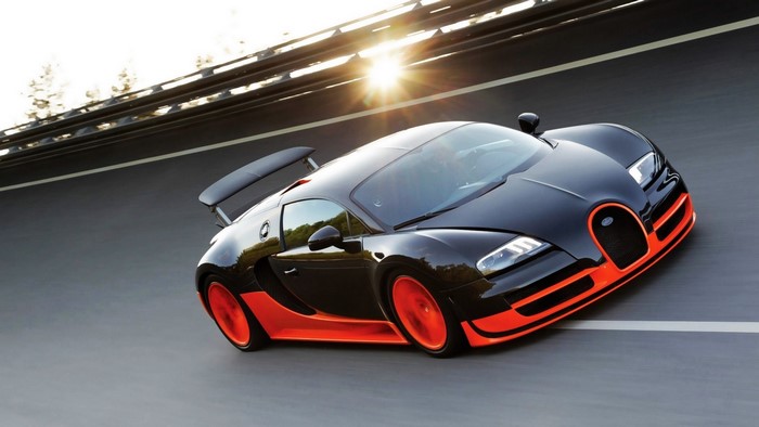 Black and orange Bugatti Veyron Super Sport on road