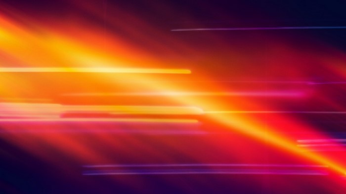 Colored Light Beams Streaking Across Dark Background