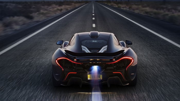 Black McLaren P1 driving on a desert road