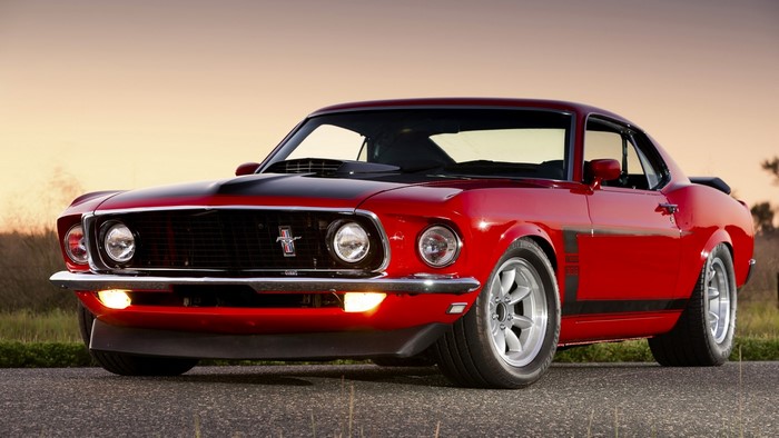 Red Ford Mustang Boss 302 parked on a road