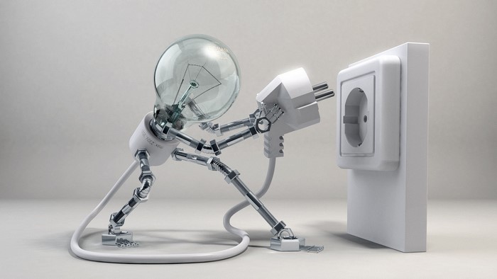 Light bulb robot plugging into wall socket