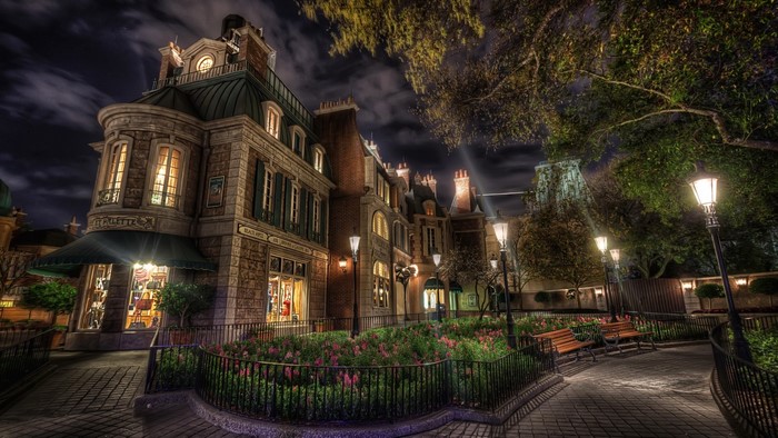 French-style building at night with flower beds