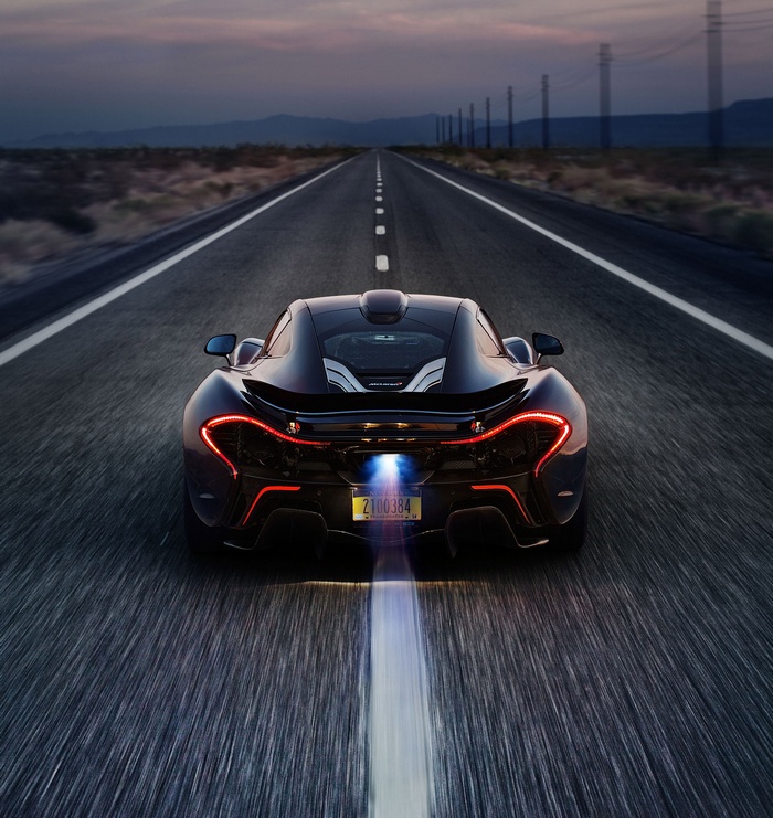 McLaren P1 on a desert road at dusk