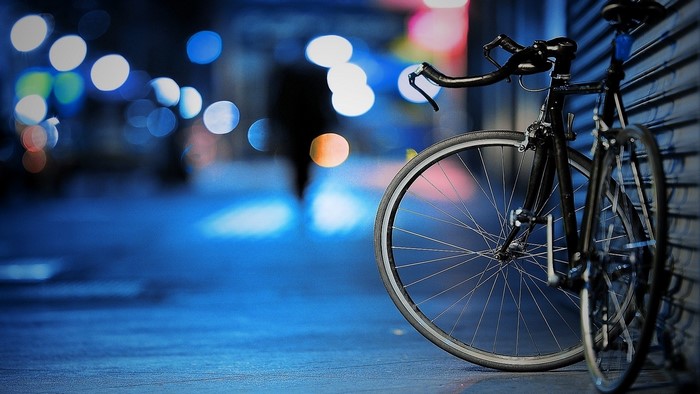 Street Bicycle Leaning Against a Wall at Night
