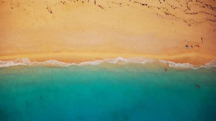 Aerial view of a sandy beach with turquoise water