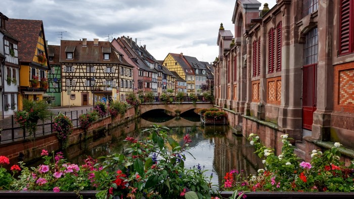 Colmar, France canal with colorful buildings and flowers