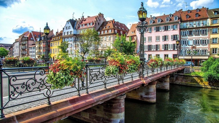 Bridge with colorful buildings and a river