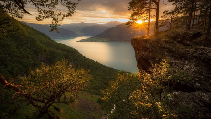 Sunset over a Fjord with Mountains and Forest