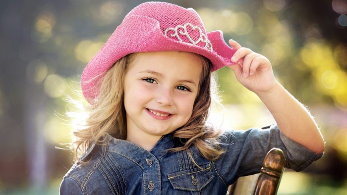 Cute girl in a pink hat