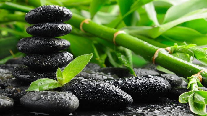Zen stones and bamboo with water droplets