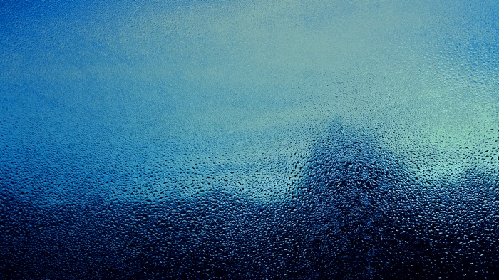Water drops on glass at dawn