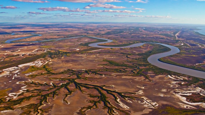 Aerial view of a winding river through a vast landscape