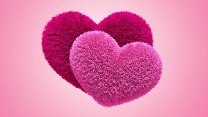 Two fluffy pink hearts on a pink background