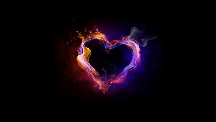 Heart shape made of colorful smoke and fire