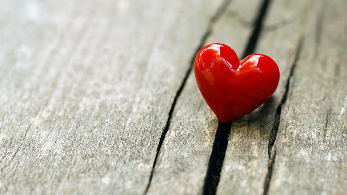 Red heart on wooden planks