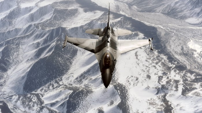 F-16 Aggressor Jet Flying Over Snowy Mountains