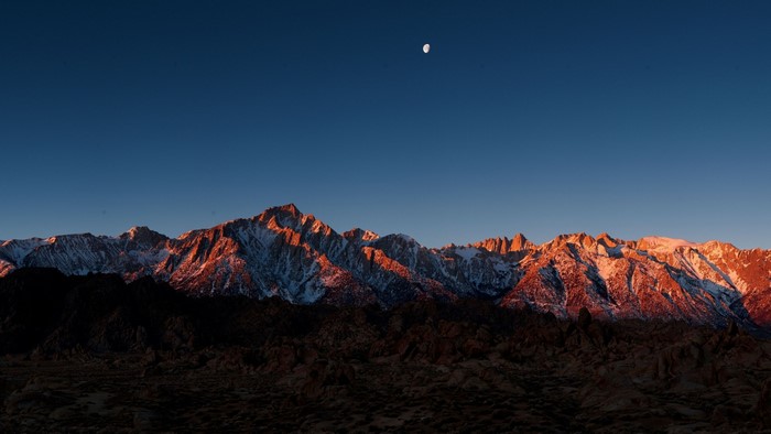 Mountain Range at Sunrise with Moon