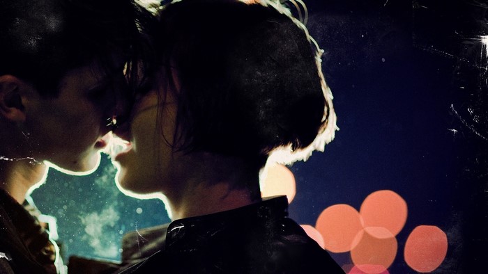 Couple kissing in the night with bokeh lights