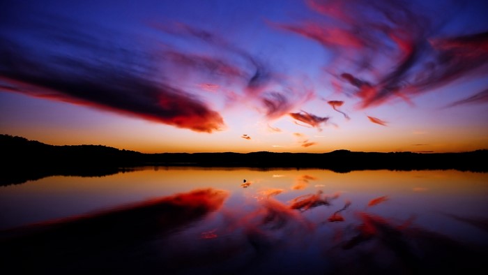Sunset over a calm lake with colorful clouds