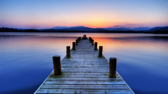 Wooden pier on a lake at sunset