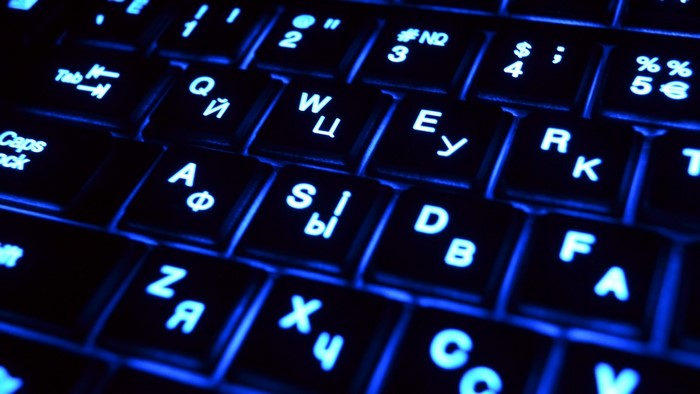 Close-up of a backlit keyboard with blue lighting