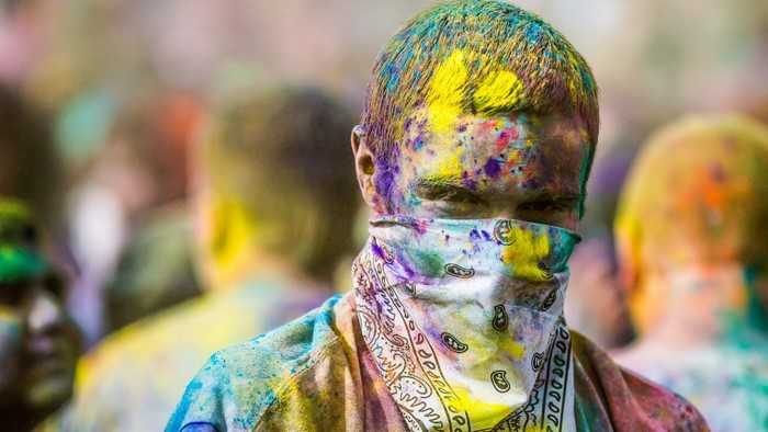 Man covered in colorful powder at Holi festival
