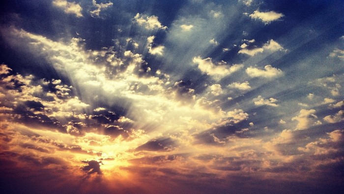 Sunbeams through clouds at sunset