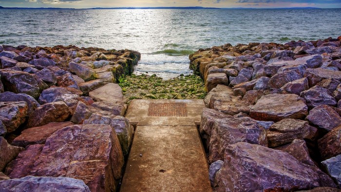Rocky beach with a path to the sea