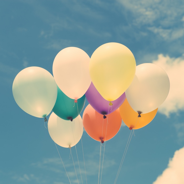 Colorful Balloons Floating in a Cloudy Sky