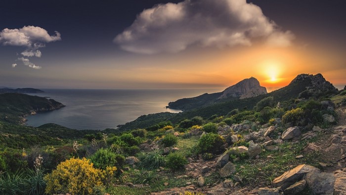Sunset over Mediterranean coast with mountains and sea