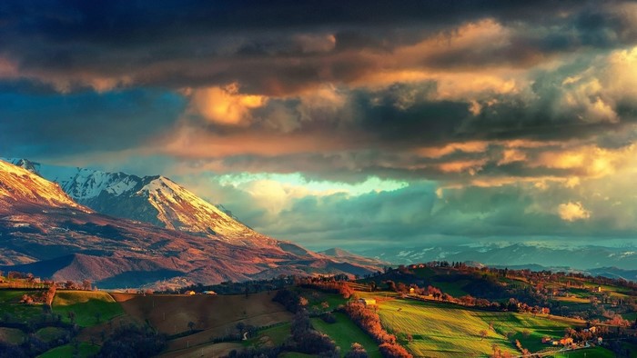 Mountain landscape with dramatic clouds at sunset