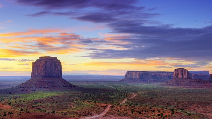Monument Valley at sunrise with colorful clouds