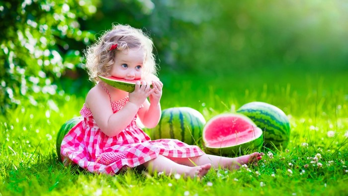 Cute Baby Eating Watermelon in Grass
