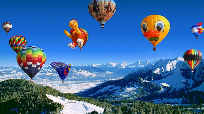 Hot Air Balloon Festival Over Snowy Mountains
