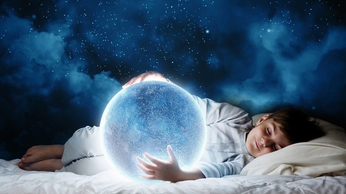 Boy sleeping and holding a glowing moon