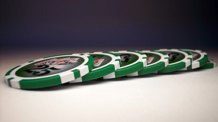 Green and white poker chips with number 25