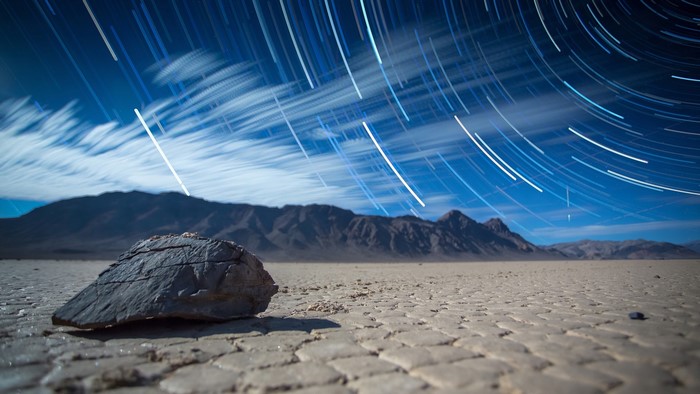 Star Trails Over Desert Landscape with Rock