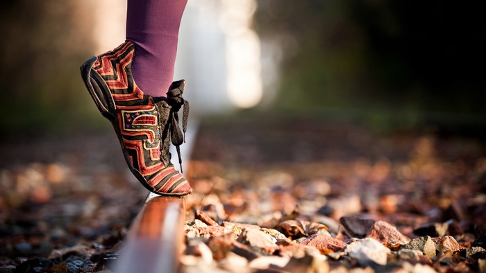 Person walking on railroad tracks
