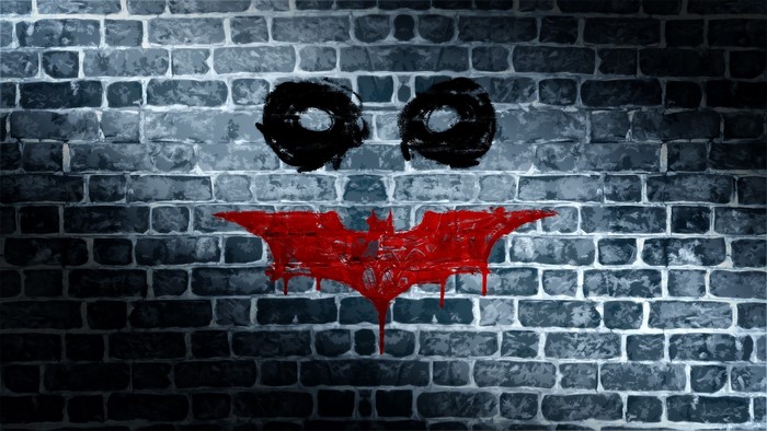 Joker graffiti on a brick wall
