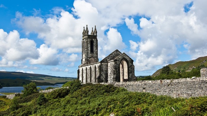 Ruined church in Ireland with a lake and hills