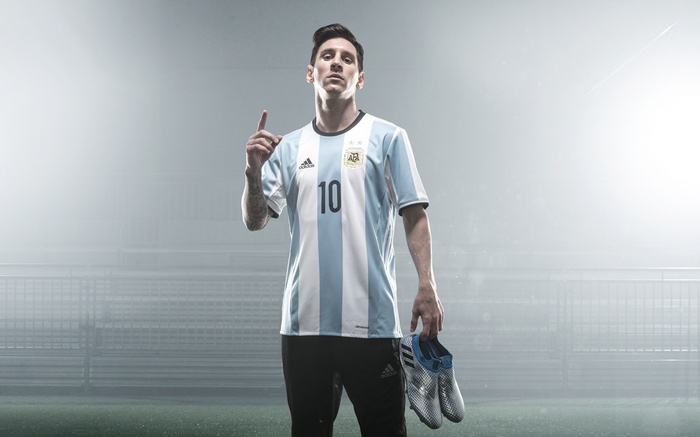 Lionel Messi in Argentina Jersey Holding Soccer Cleats