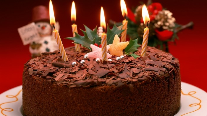 Chocolate birthday cake with candles and decorations